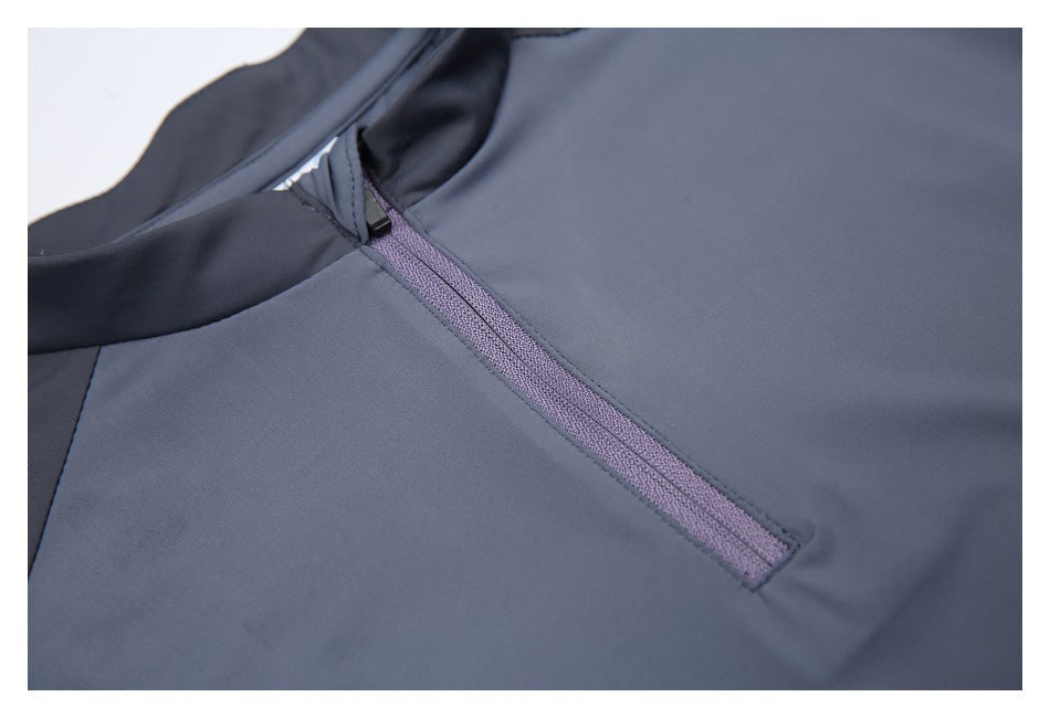 Close-up of the gray top’s short purple-gray front zipper and surrounding seams.