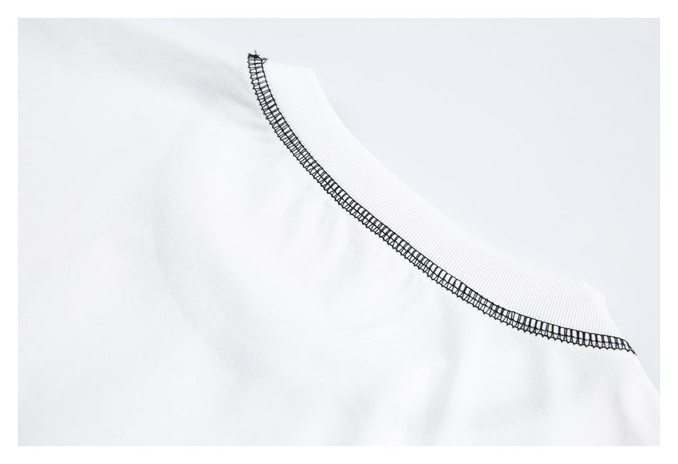 Close-up of a white garment neckline edged with black overlock stitching.