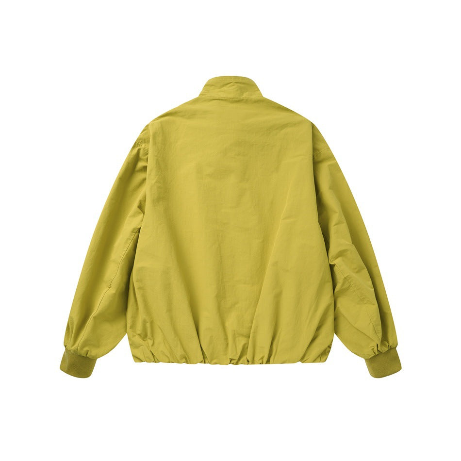 Back view of a mustard yellow jacket with a stand collar, gathered hem, and ribbed cuffs.