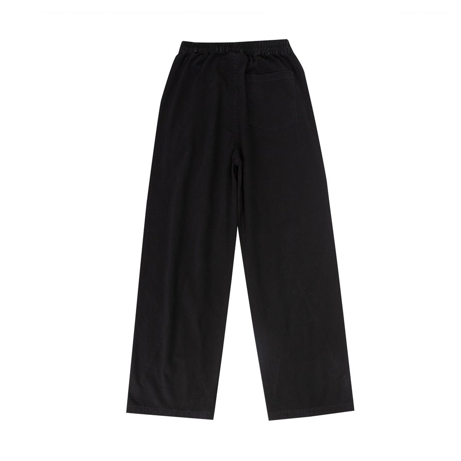 Back view of black wide-leg pants with an elastic waistband and a single rear pocket.