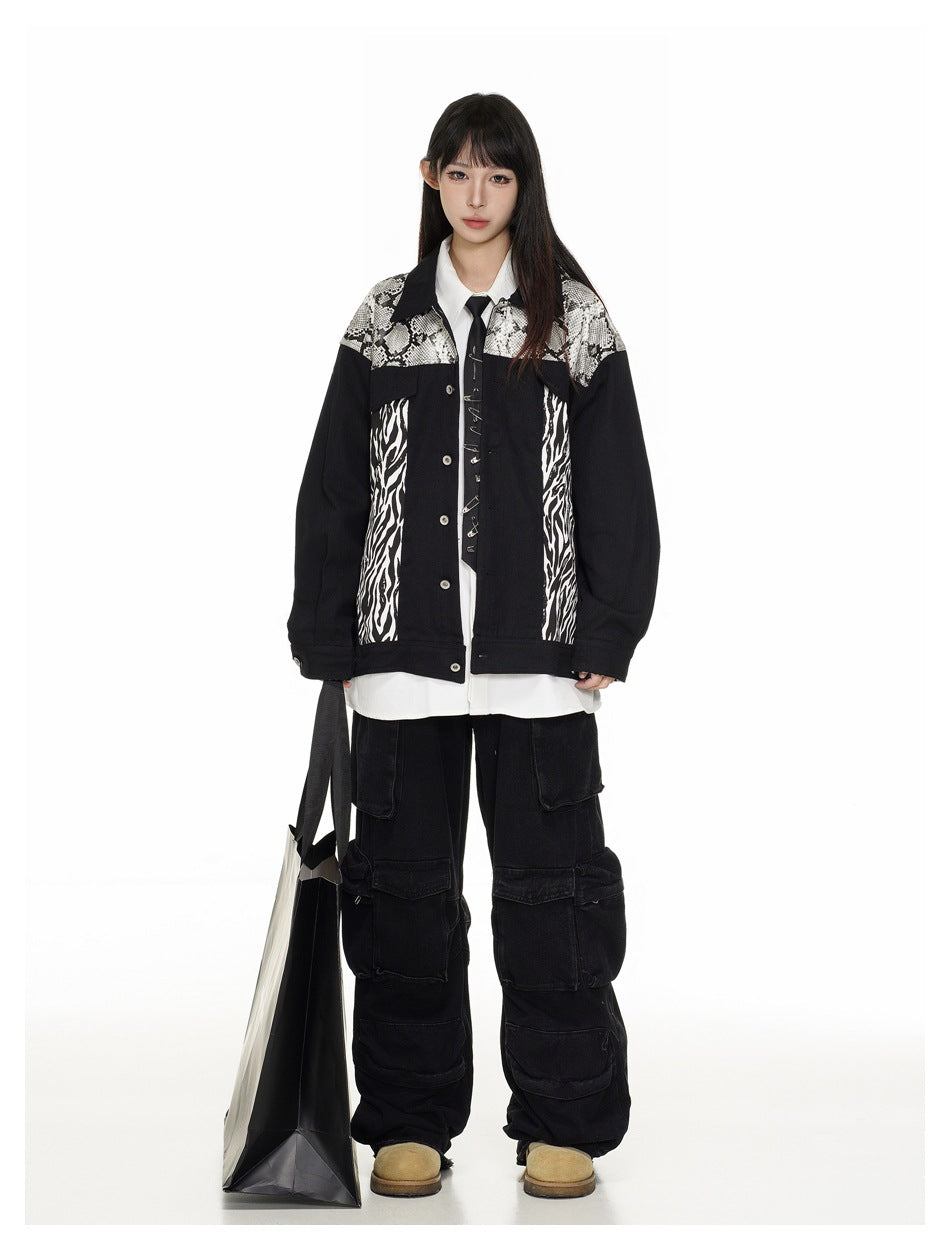 Full-length front view of a model in a black jacket with snakeskin and zebra-print panels, styled with a white shirt and
