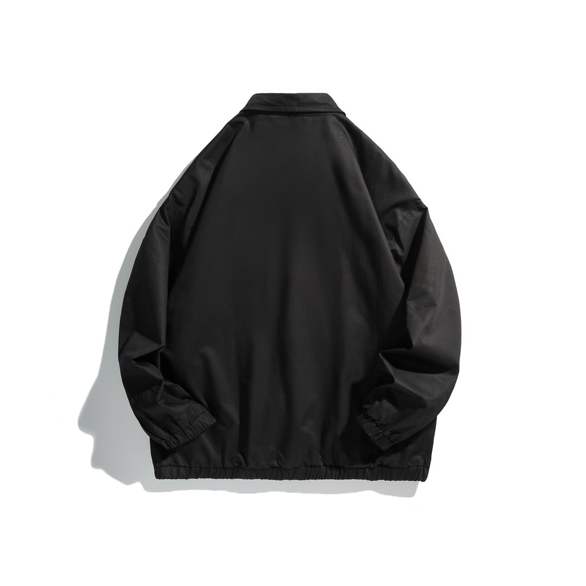Back view of a black collared jacket with long sleeves and elastic cuffs and hem.