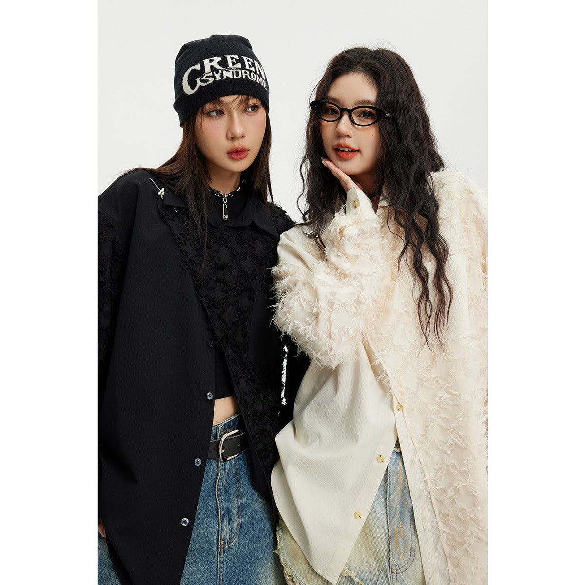 Two models pose in contrasting black and ivory collared shirts with shaggy textured panels.