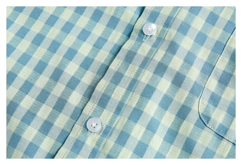 Close-up of the blue and pale yellow gingham shirt's white buttons, front placket, and chest pocket.