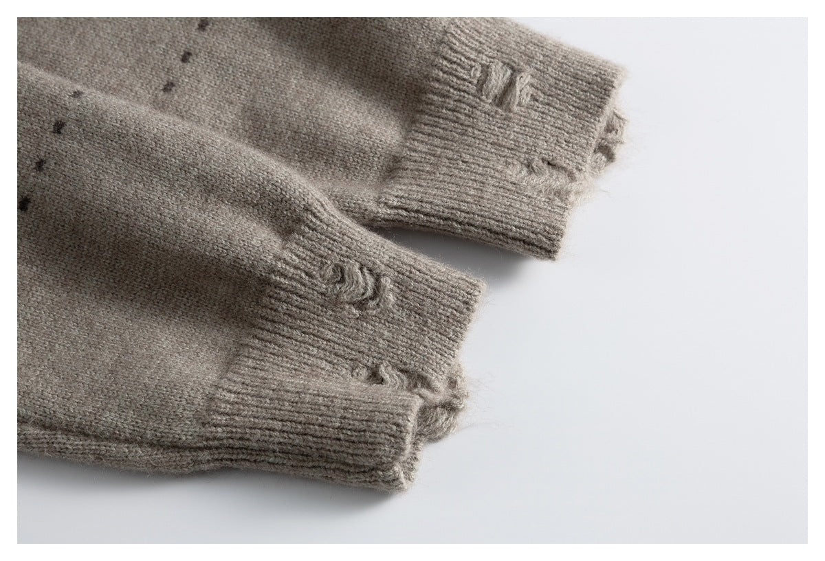 Close-up of two taupe knit sleeve cuffs with ribbed edges and small raised stitched details.