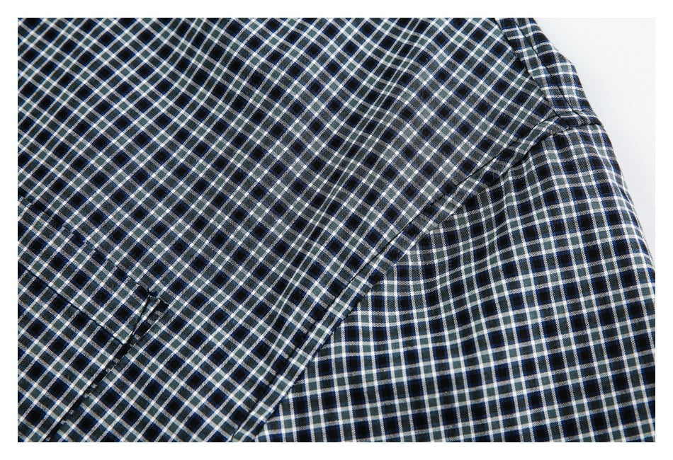Close-up of the checked shirt's sleeve and seam construction.