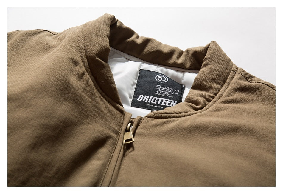 Brown jacket collar and zipper close-up showing the inner lining and neck label.