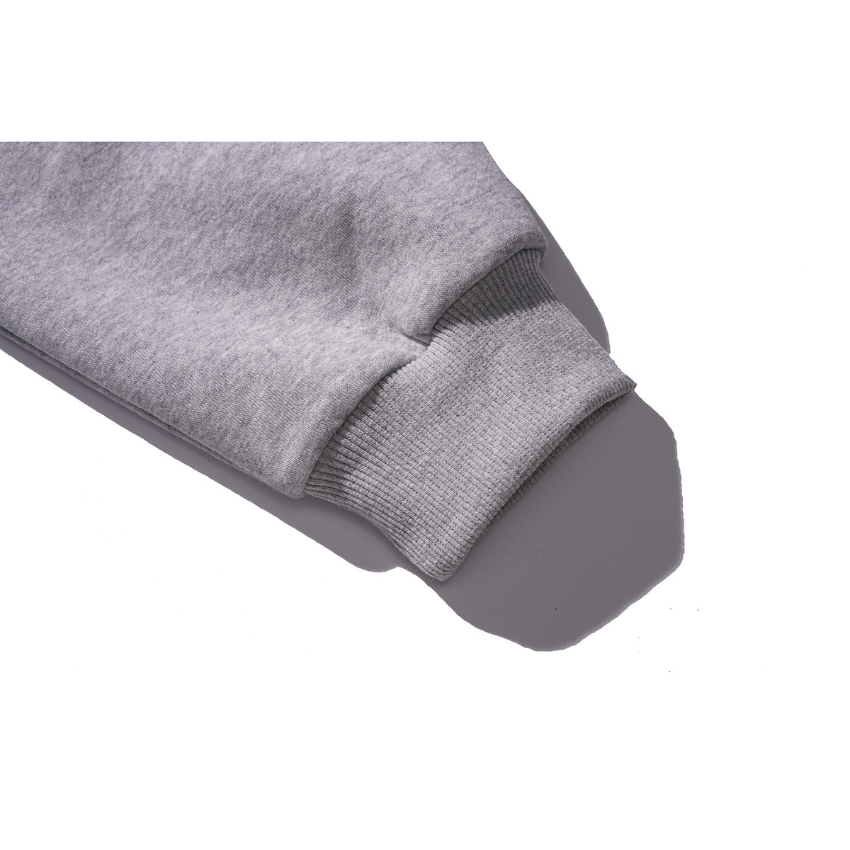 Close-up of a gray sweatshirt sleeve ending in a wide ribbed cuff.