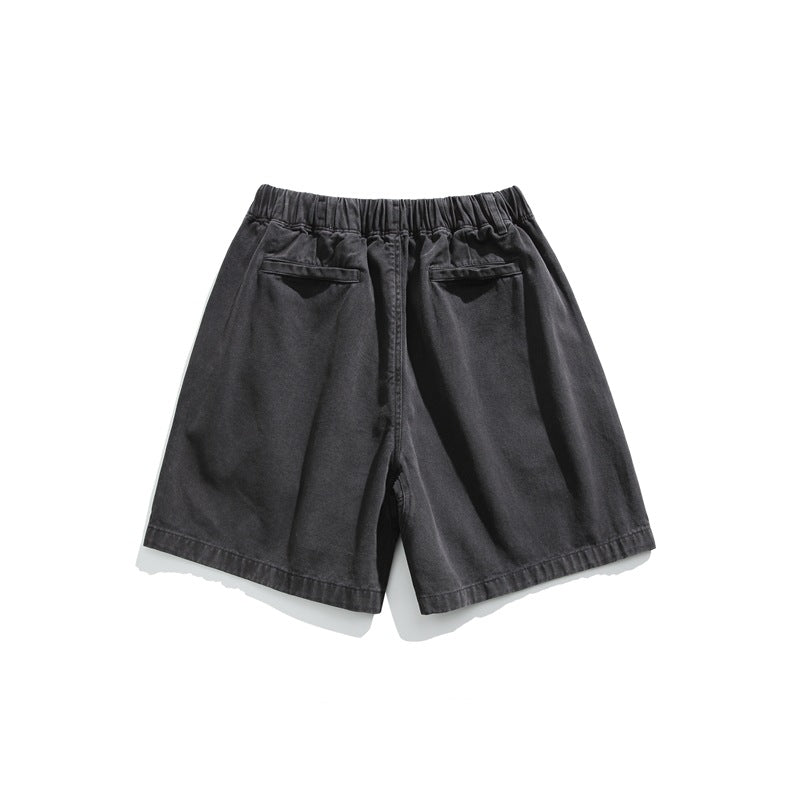 Rear view of charcoal black shorts with an elastic waistband and two back pockets, displayed flat on white.