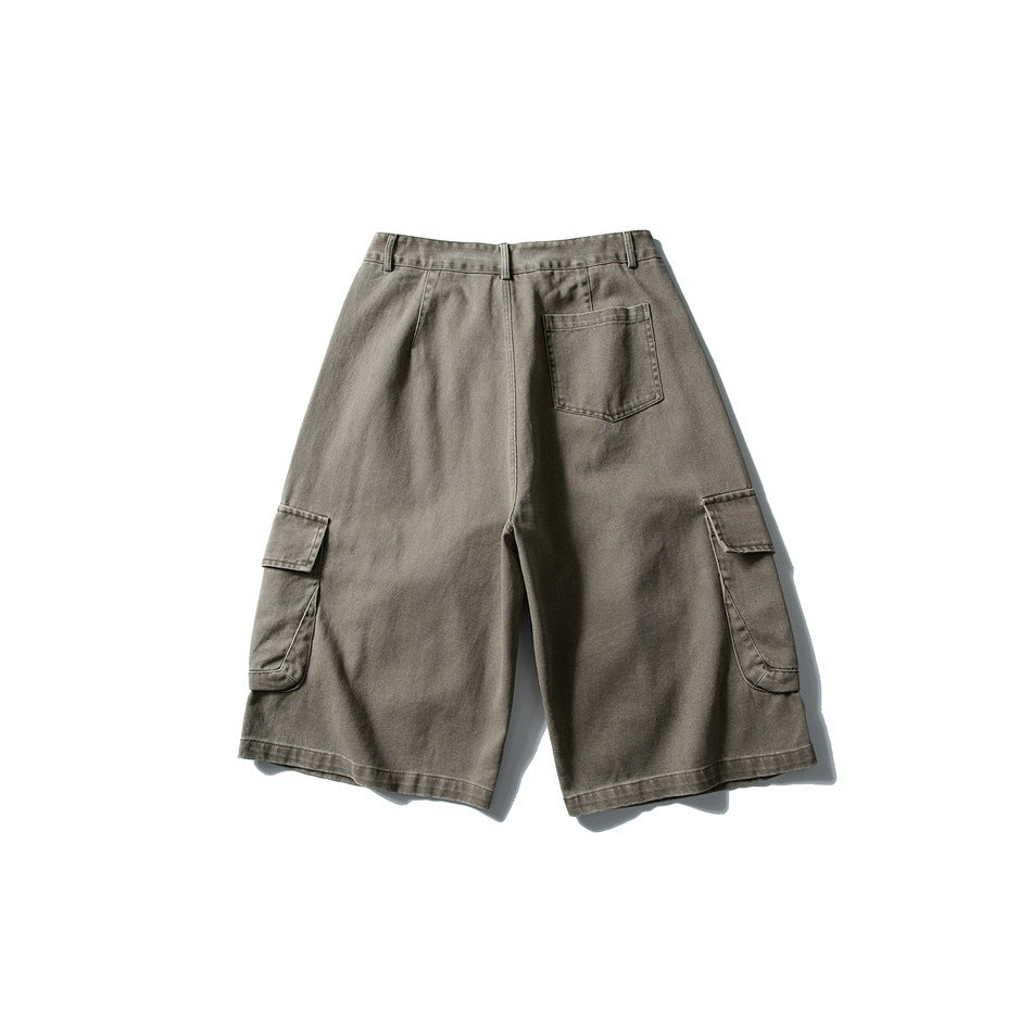 Back view of dark olive-gray cargo shorts with a single back pocket and flap pockets on both legs.
