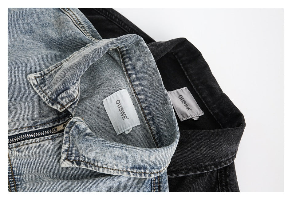 Close-up of light-wash and black denim jacket collars, each showing a sewn-in label.
