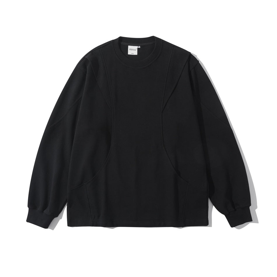 Black long-sleeve crew neck pullover with curved seam panels and ribbed cuffs, shown flat from the front