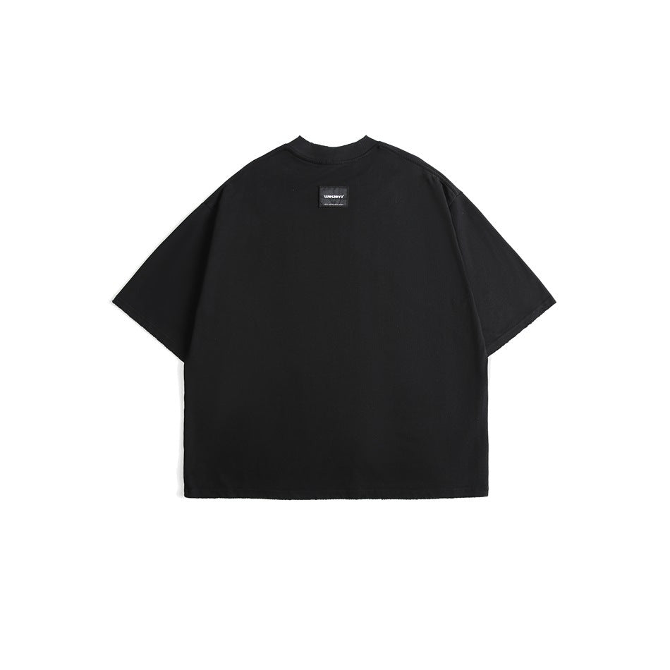Back view of an oversized black T-shirt with short sleeves and a small black neck label.