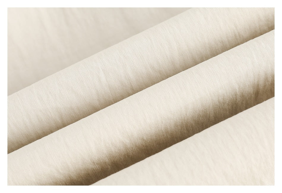 Close-up showing the fine surface texture and folds of ivory fabric.
