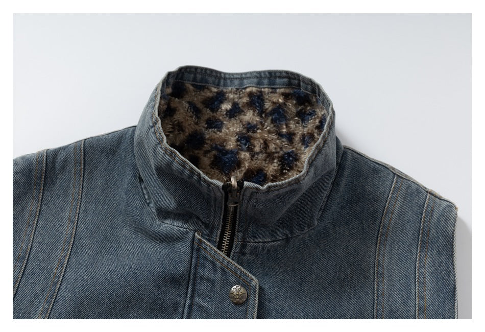 Close-up of the vest's blue denim back, raised collar, patterned lining, zipper, and decorative snap.