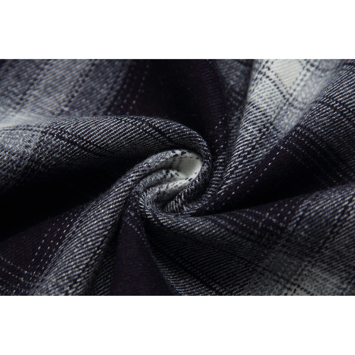 Macro view of black-and-gray plaid fabric folded to show its woven texture.