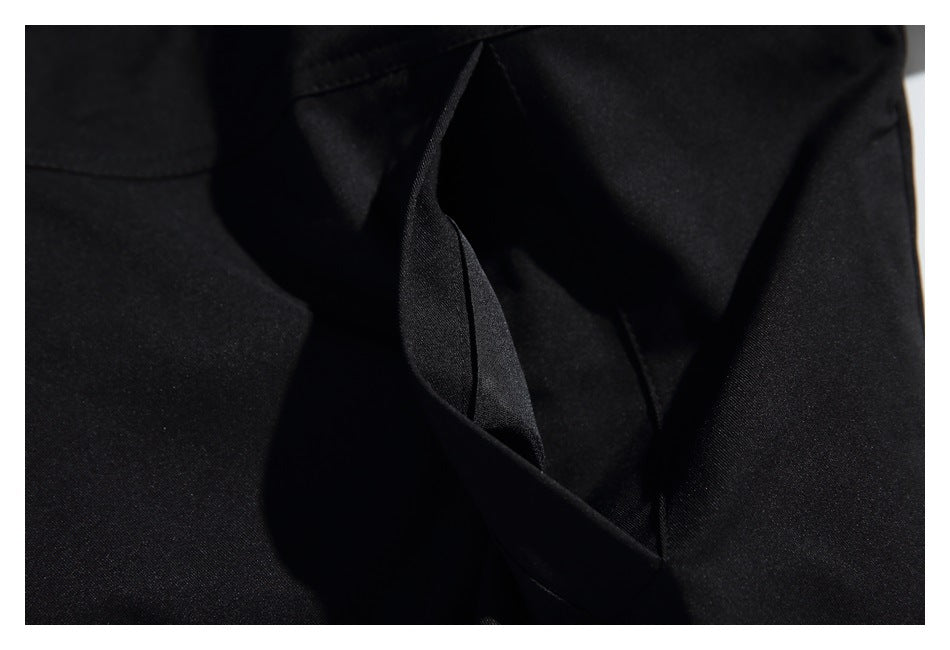 Close-up of an open pocket on a black garment.