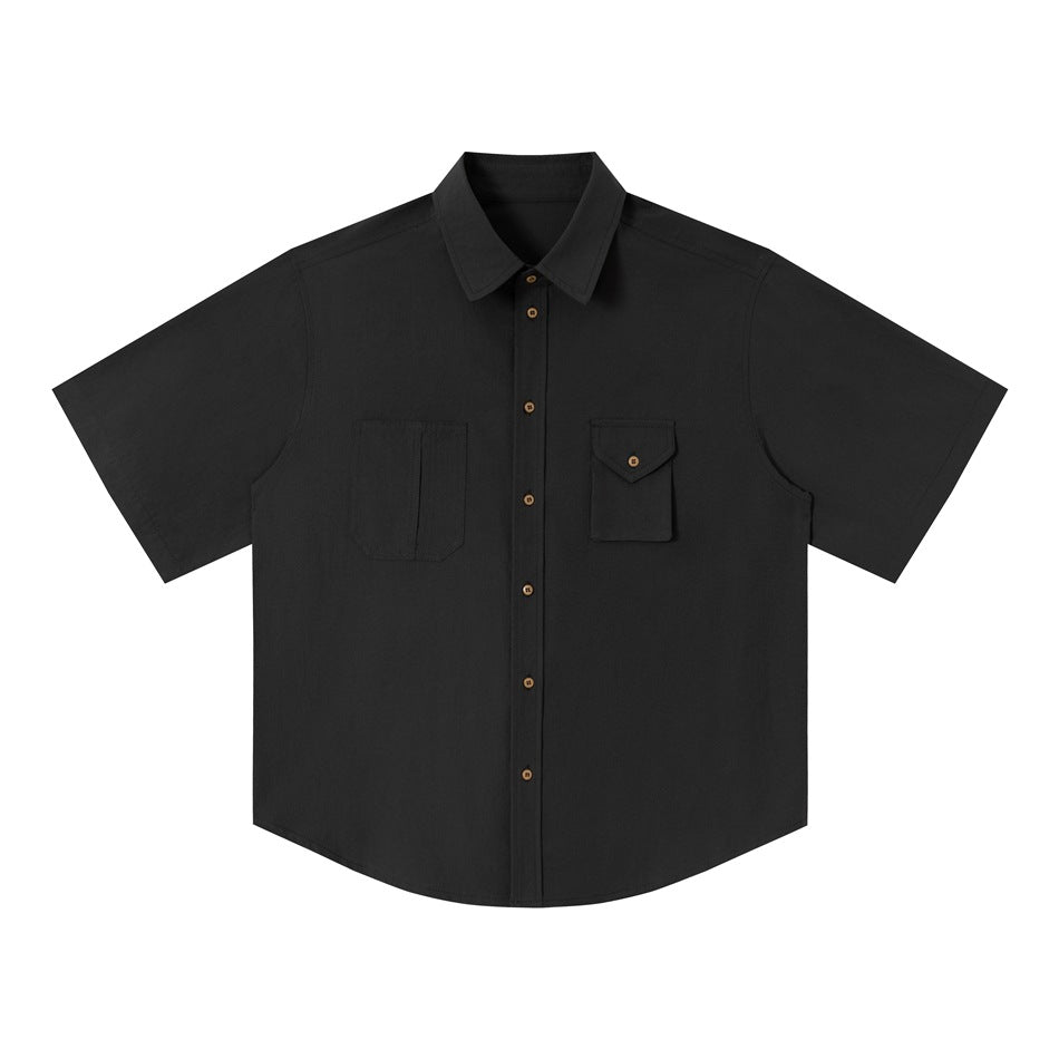 Dark gray short-sleeve work shirt flat lay, front view with asymmetrical chest pockets and brown buttons