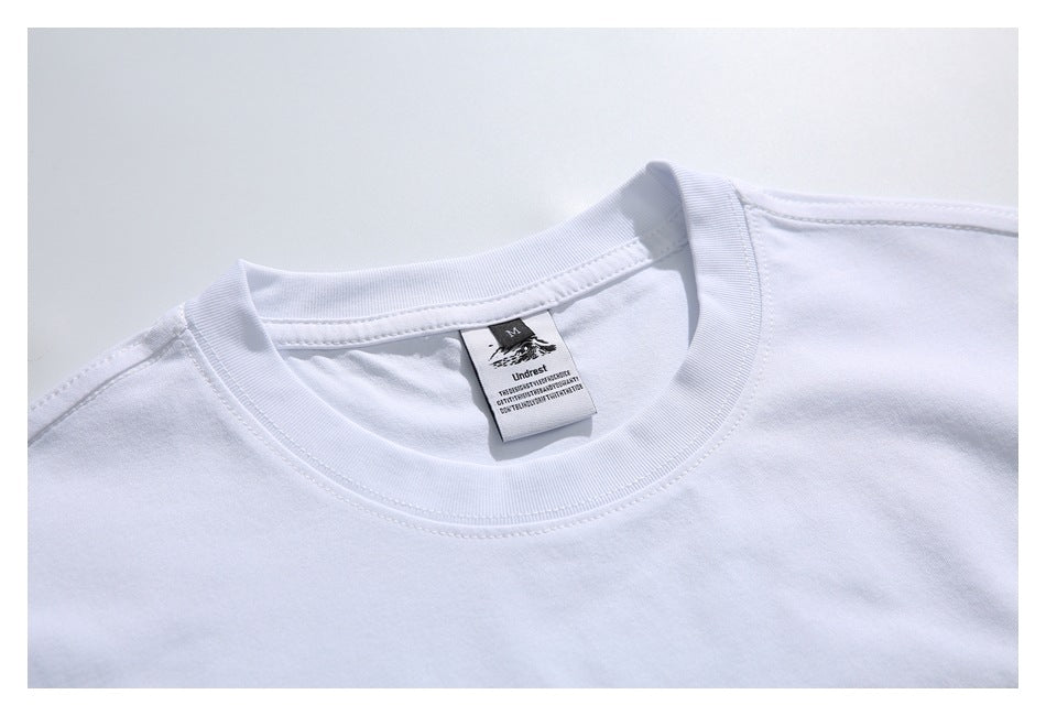 Close-up of a white T-shirt’s ribbed crew neck and sewn-in size M label.