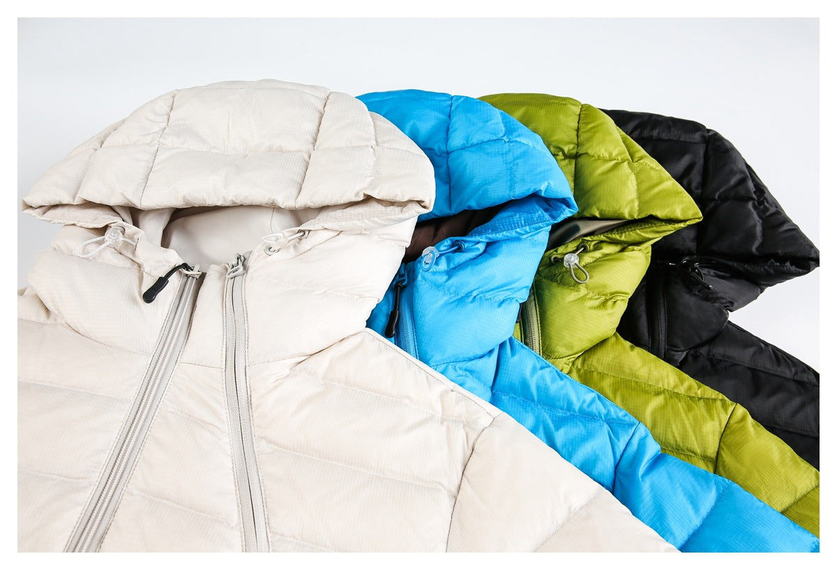 Four hooded puffer jackets arranged together in ivory, bright blue, olive green, and black.