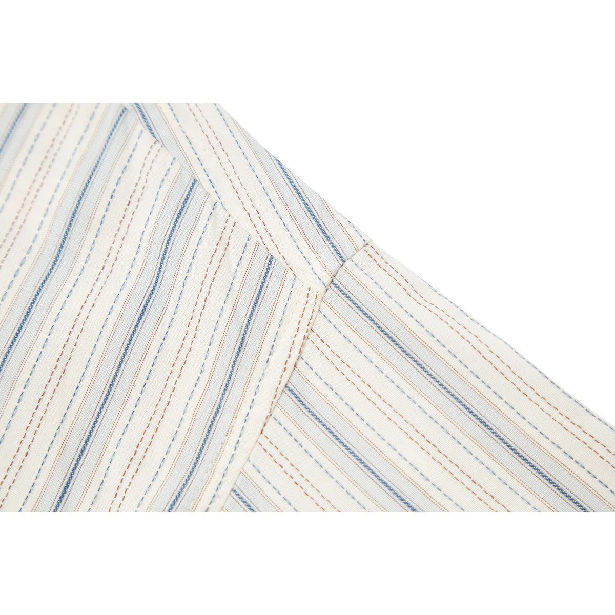 Close-up of a striped ivory shirt shoulder seam with blue and brown lines.
