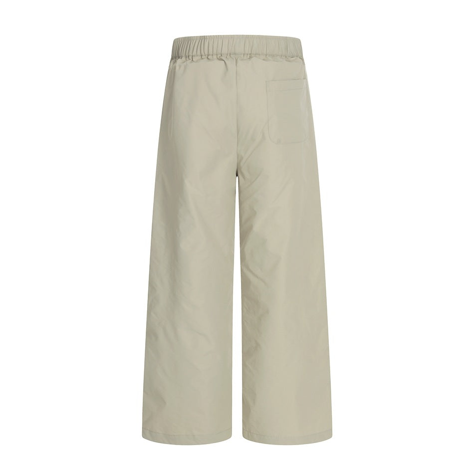 Back view of light beige wide-leg trousers with an elastic waistband and a single rear pocket.