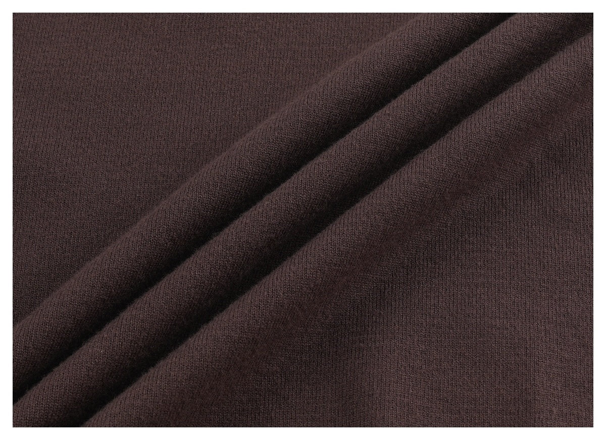 Macro view of dark brown knit fabric folded into diagonal ridges.