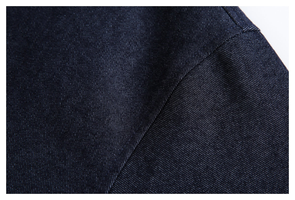 Close-up of dark navy fabric and a diagonal stitched seam.