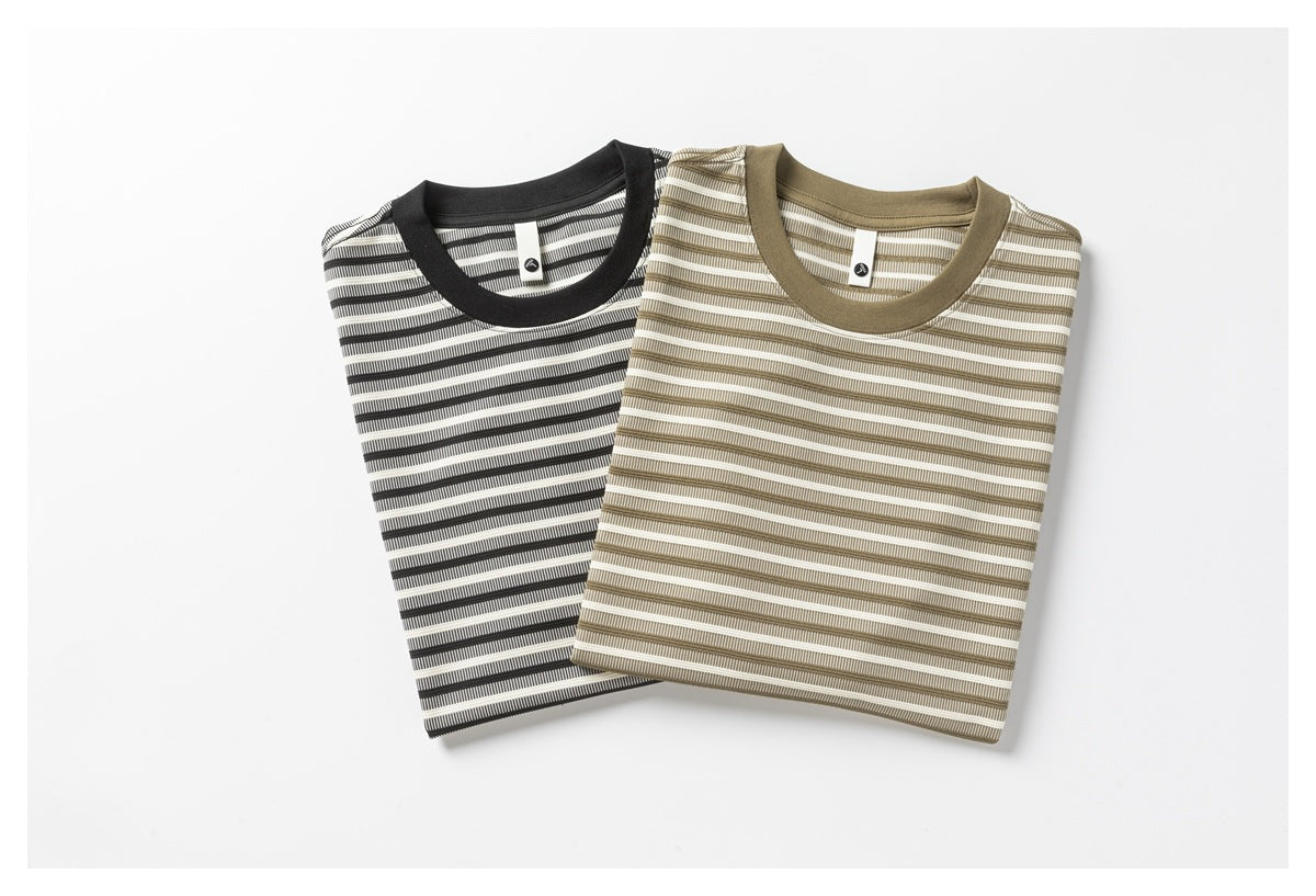 Two folded striped crew-neck T-shirts in black and white and taupe and white, with matching solid collars.