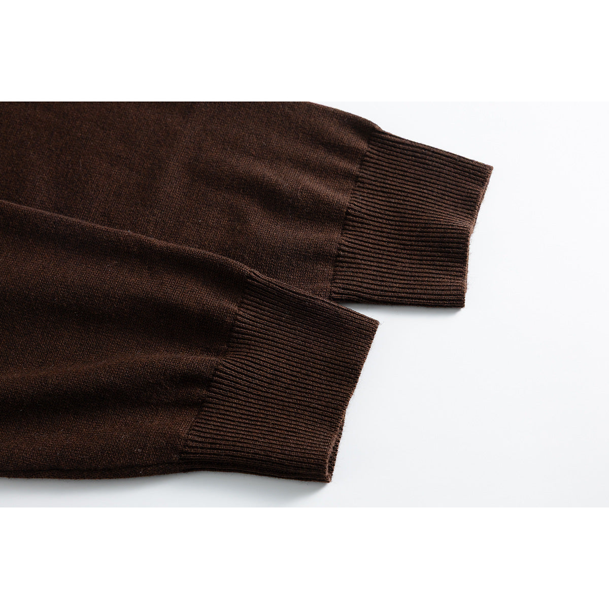 Close-up of two dark brown cardigan sleeves showing ribbed cuffs and knit texture.