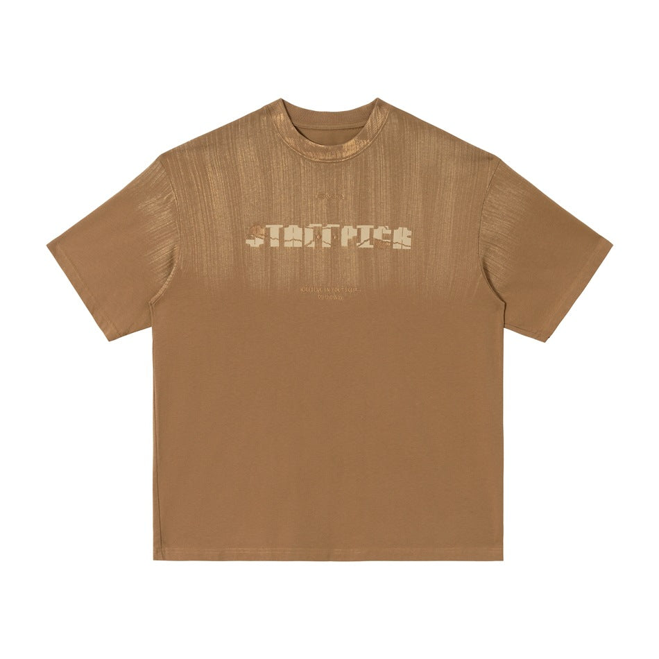 Coffee brown short-sleeve crew-neck T-shirt with brushed streak finish and pixel-style chest logo, flat lay