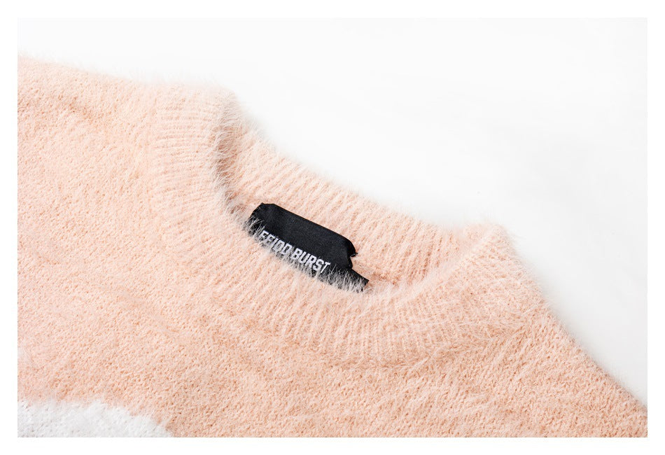 Close-up of the blush-pink sweater neckline and a black sewn-in label.