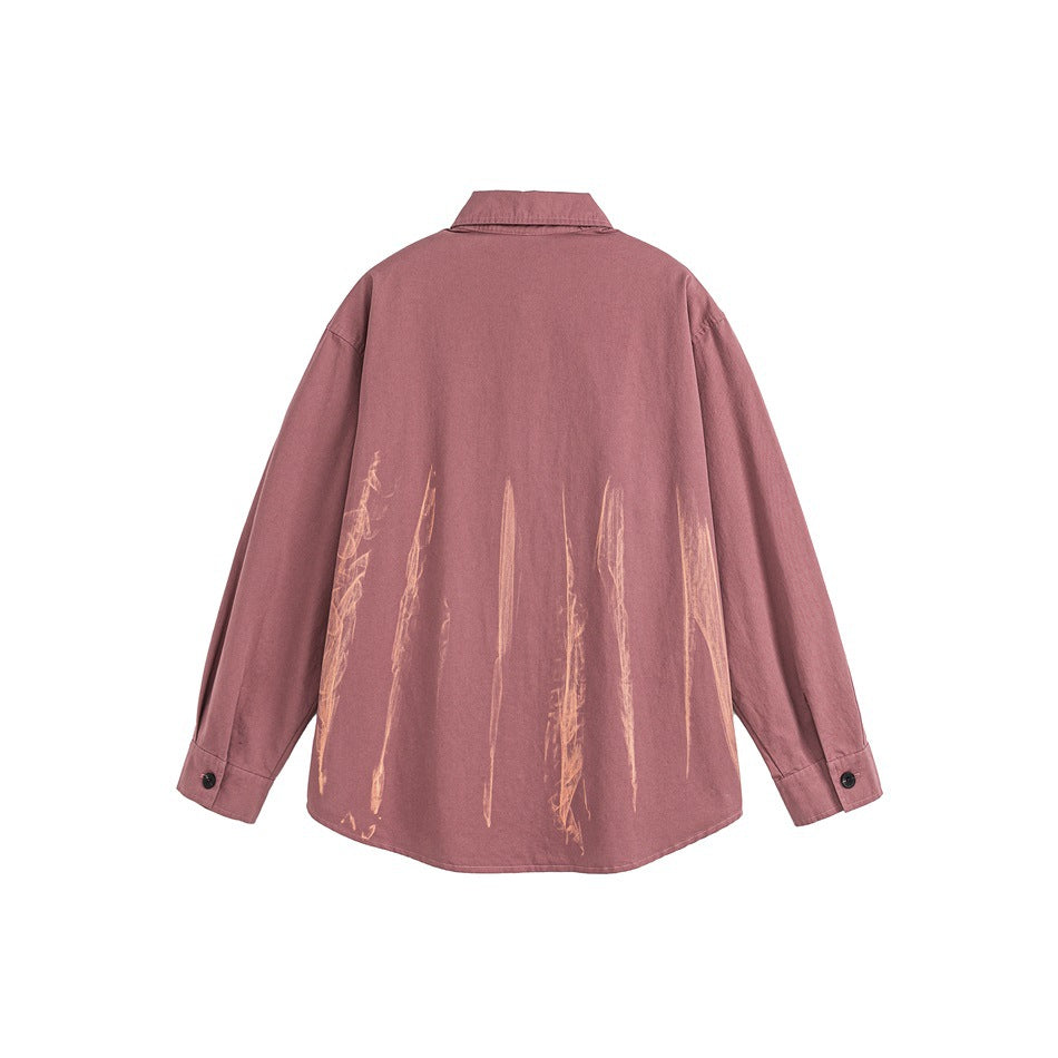 Back view of a dusty rose long-sleeve button-up shirt with pale brushstroke graphics across the lower back.