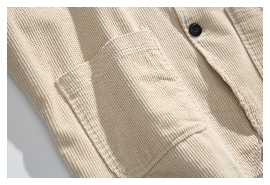Close-up of a large patch pocket on the cream jacket, showing its stitching and ribbed texture.