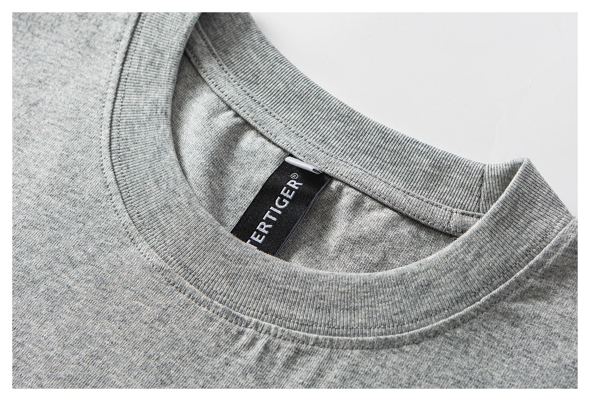 Close-up of a heather-gray crew neckline with a black sewn neck label.
