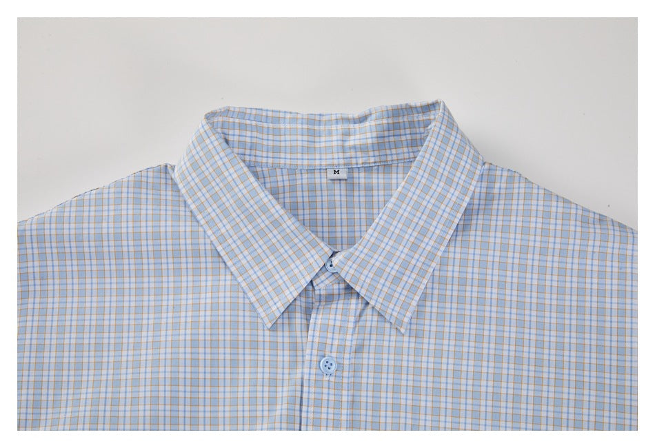 Flat view of a light blue and orange checked button-up shirt, showing its pointed collar and front placket.