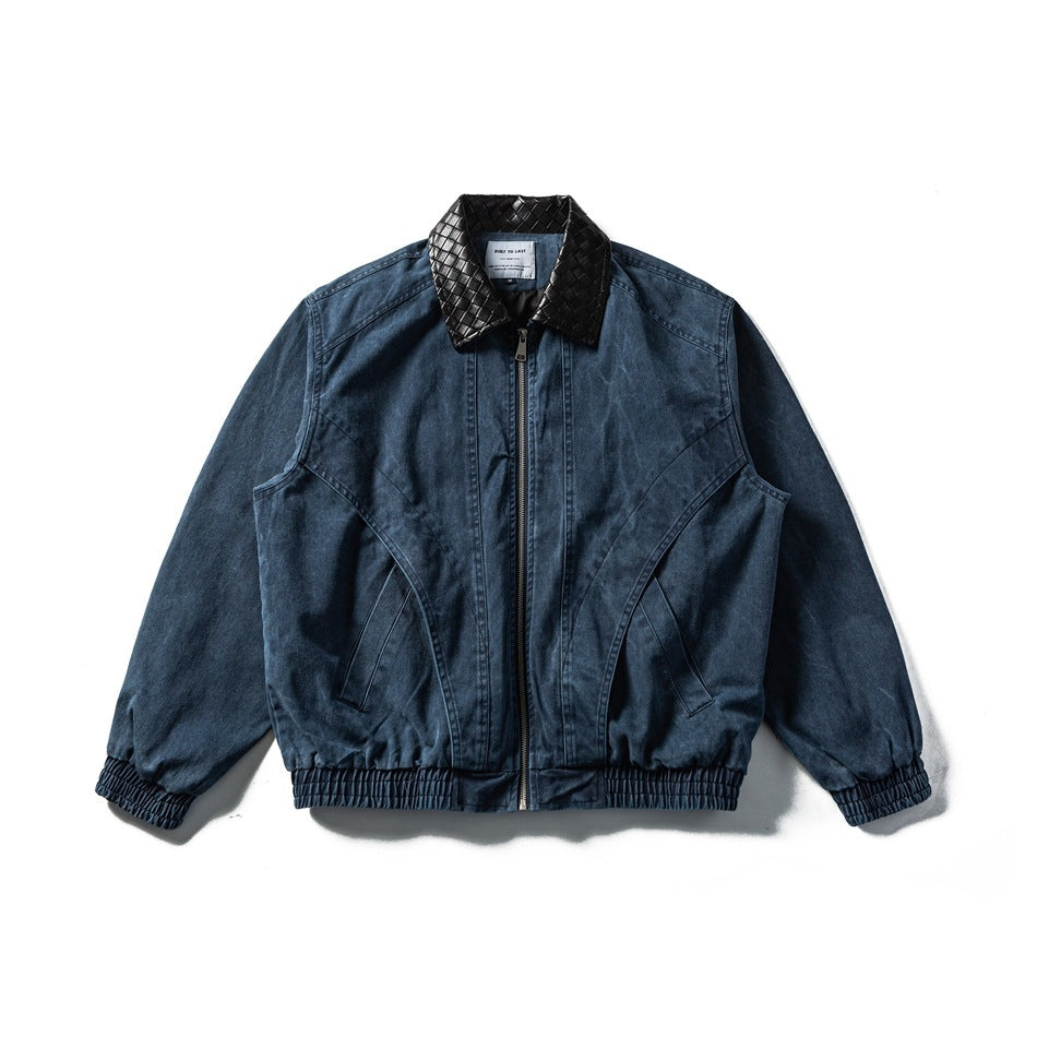 Washed navy zip-front jacket with black woven-pattern collar, curved front seams and elastic hem and cuffs, flat lay