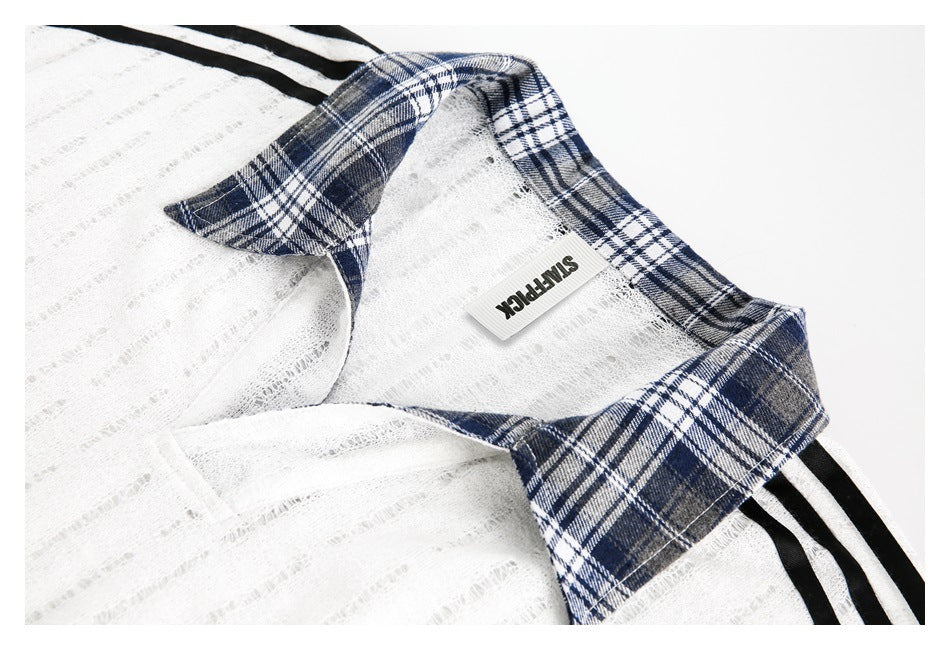 Close-up of the white textured top's navy plaid collar and inner garment label.