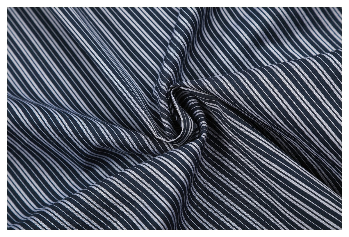 Close-up of draped navy fabric with fine white stripes, showing its folds and pattern.