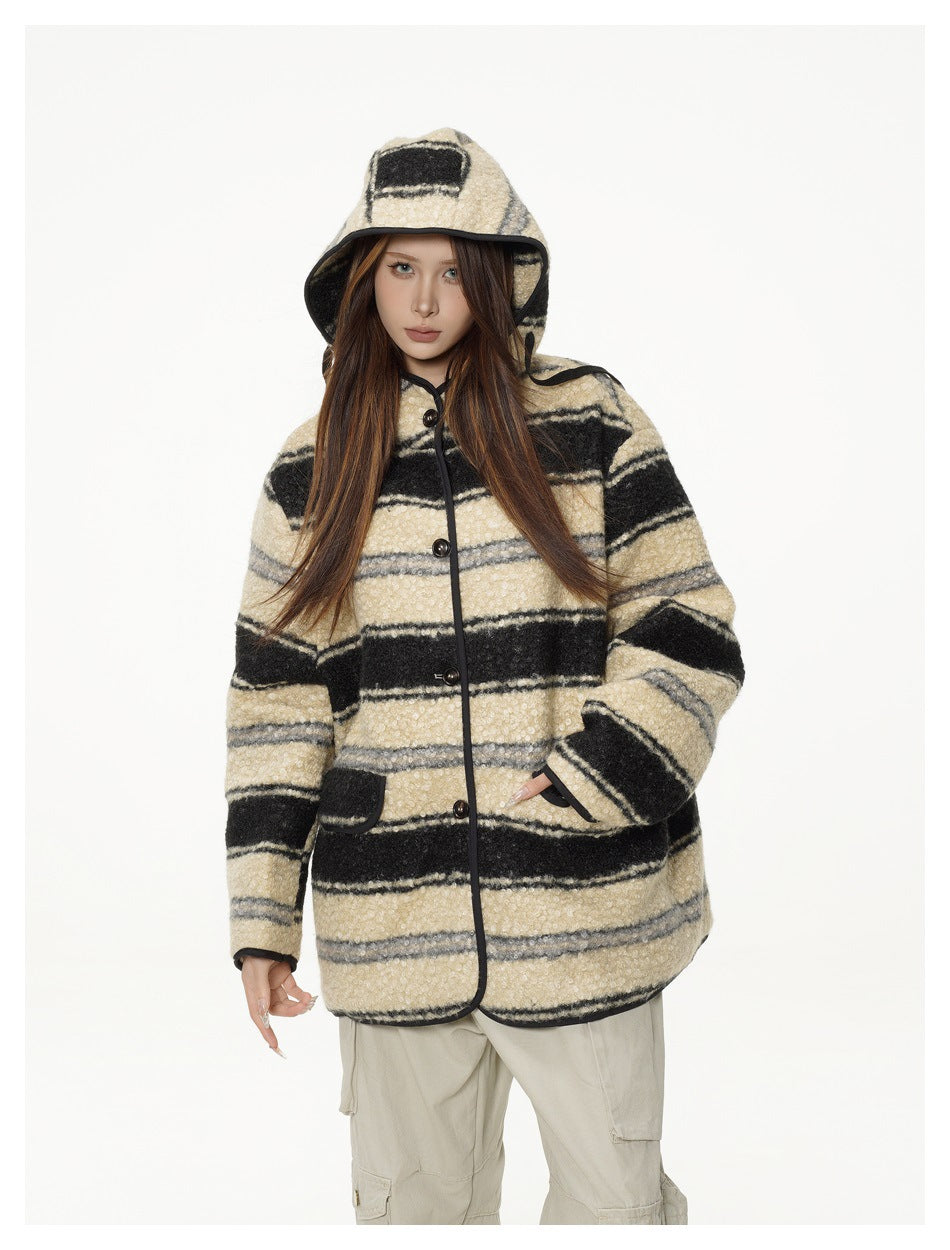 Model wearing a striped hooded button-front jacket with the hood up, hand in pocket, with beige cargo pants