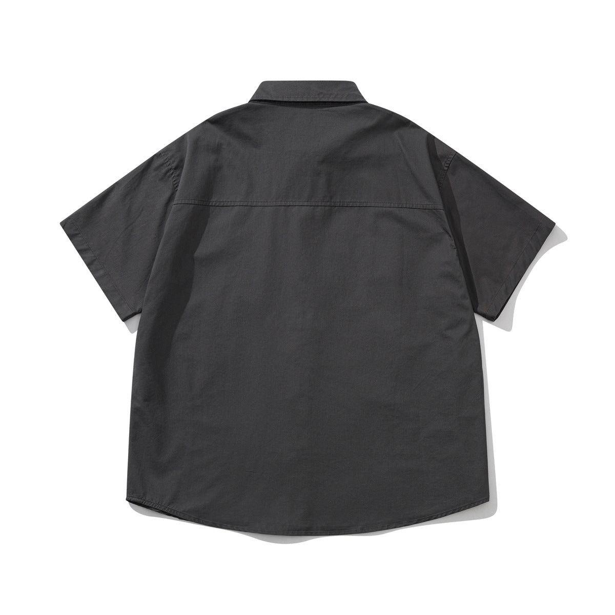 Back view of a charcoal gray short-sleeve button-up shirt laid flat, with a yoke seam.