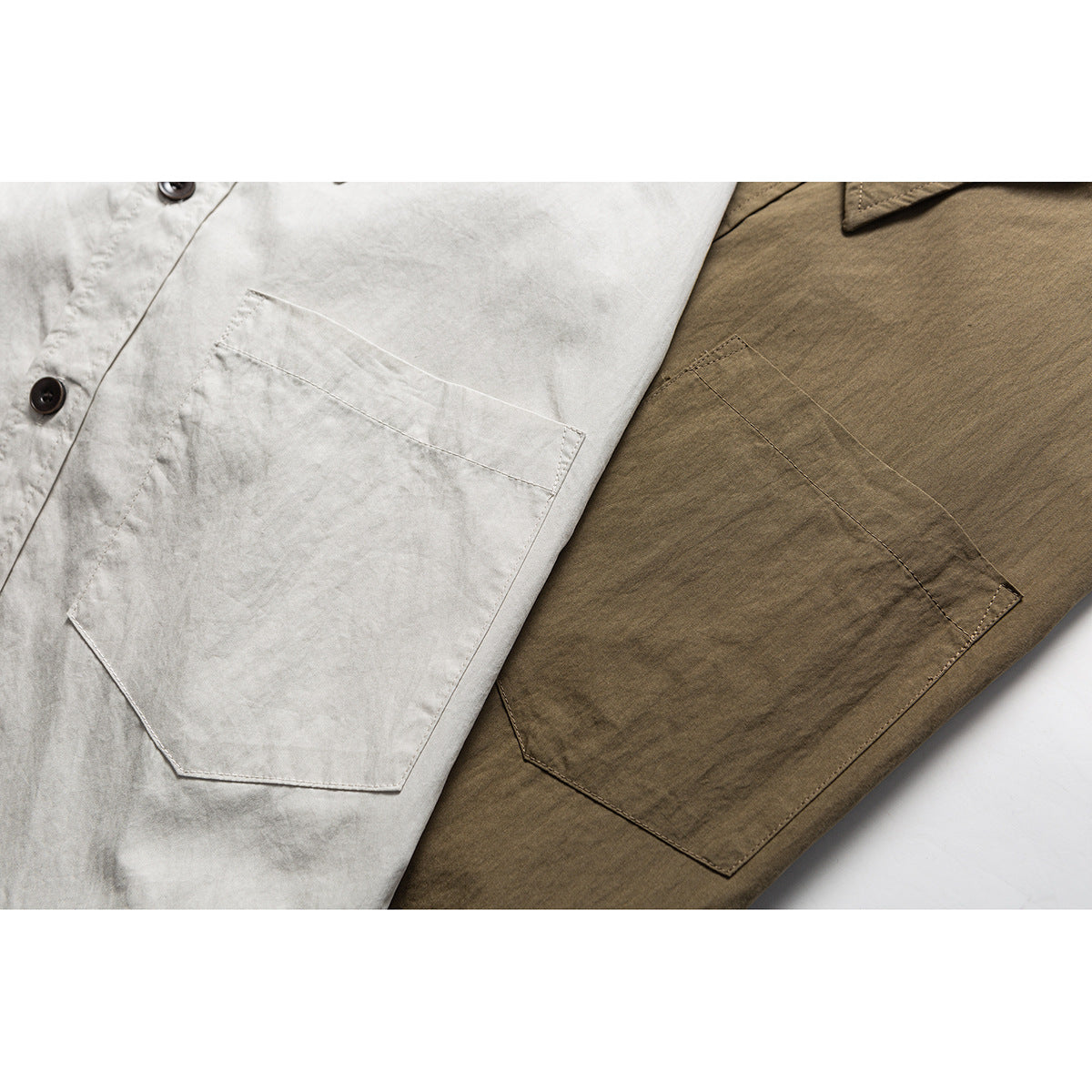 Close-up of chest pockets on light gray and olive button-up shirts, with part of each button placket visible.