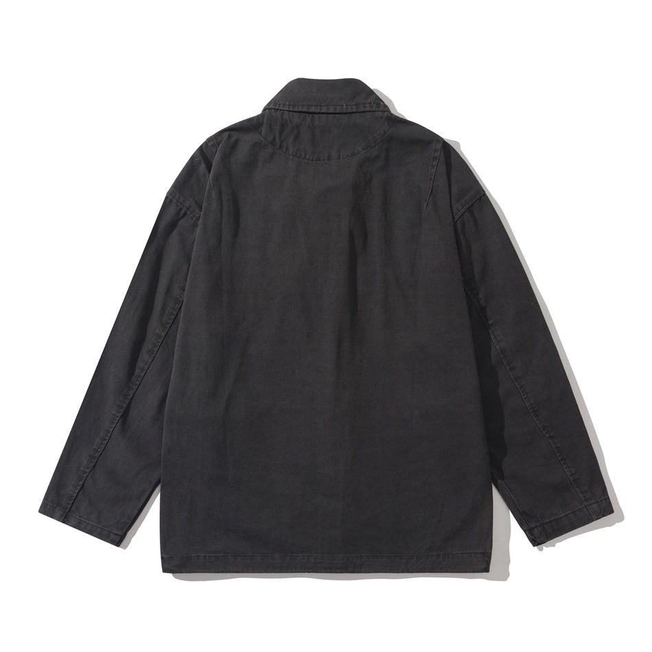 Back view of black utility jacket showing back yoke seam, pointed collar and long sleeves, flat lay