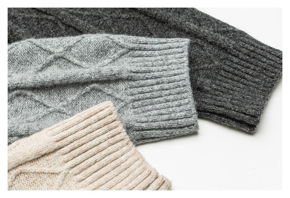 Close-up of ribbed cuffs on gray, charcoal, and cream cable-knit sweaters.