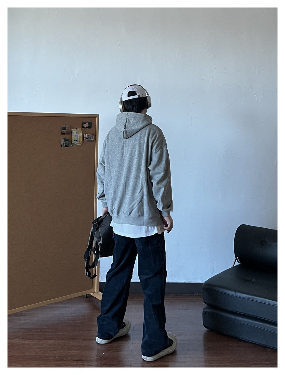 Person wearing a light gray hooded sweatshirt, viewed from behind with the hood down.