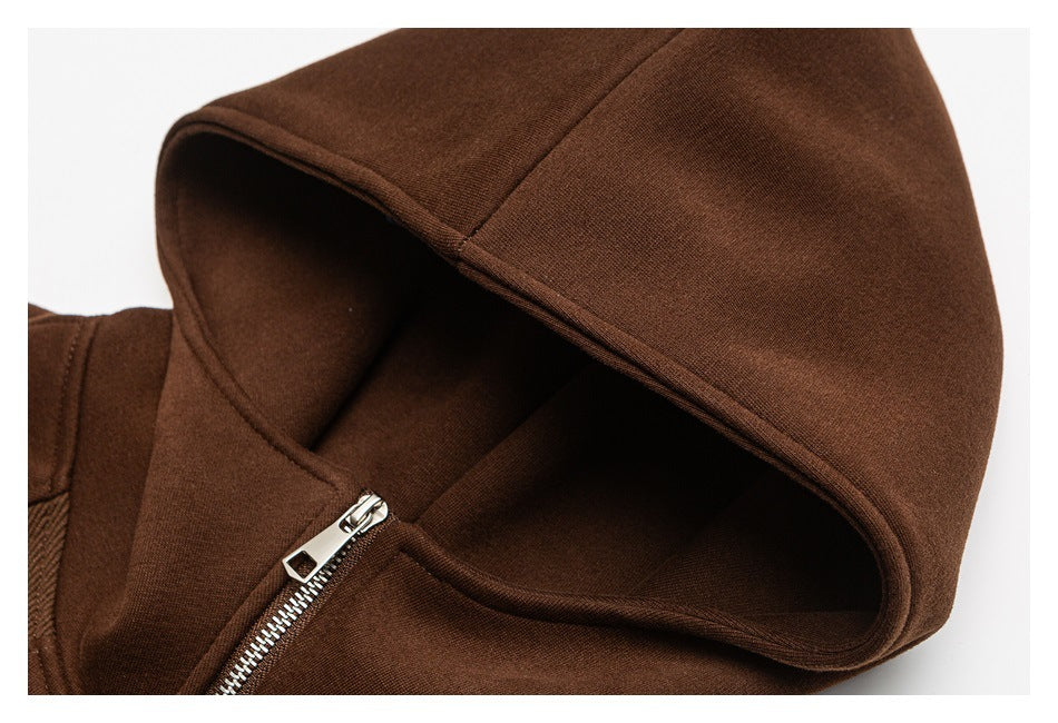 Close-up of a dark brown hood and silver zipper on a garment.