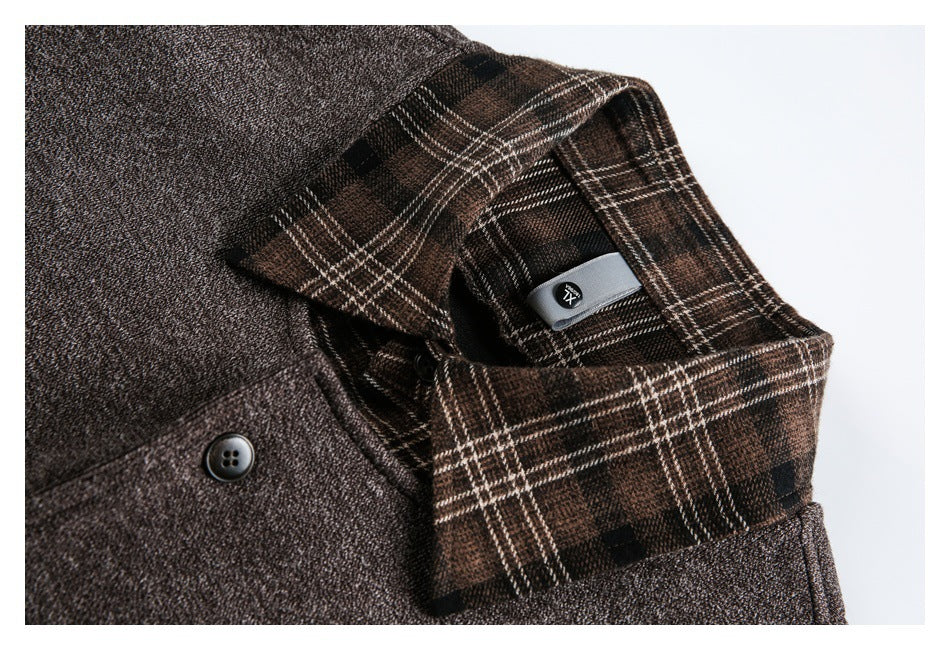 Close-up of a brown textured jacket collar with brown plaid lining and a dark button.