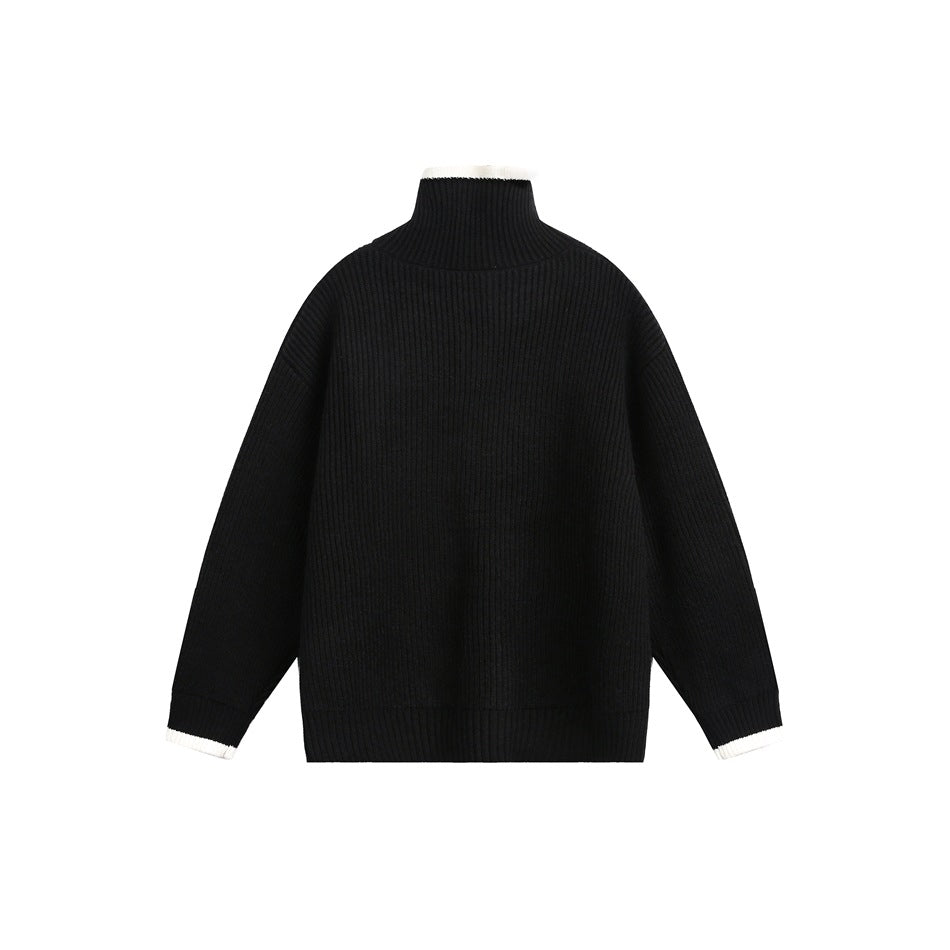 Back view of a black ribbed sweater with a high collar and white trim at the collar and cuffs.