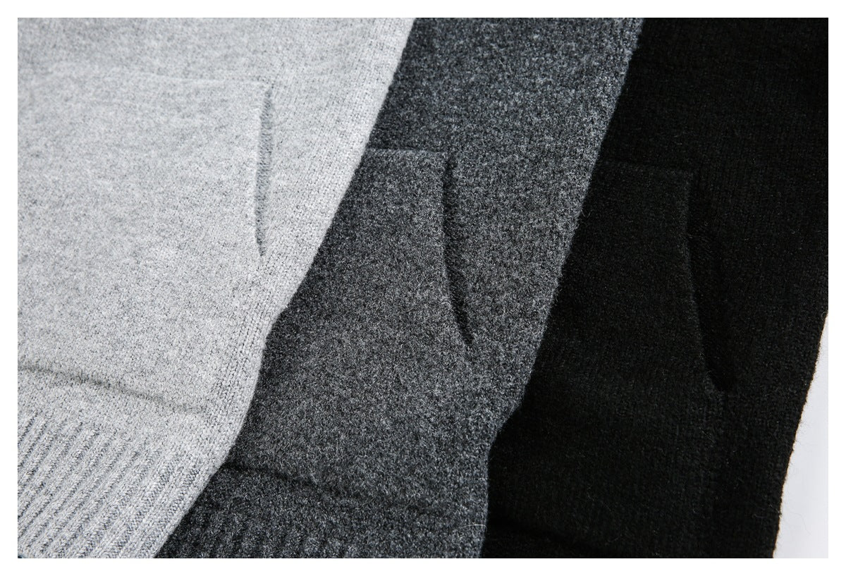 Close-up of three knit sweaters in light gray, charcoal, and black, showing the knit texture and seams.