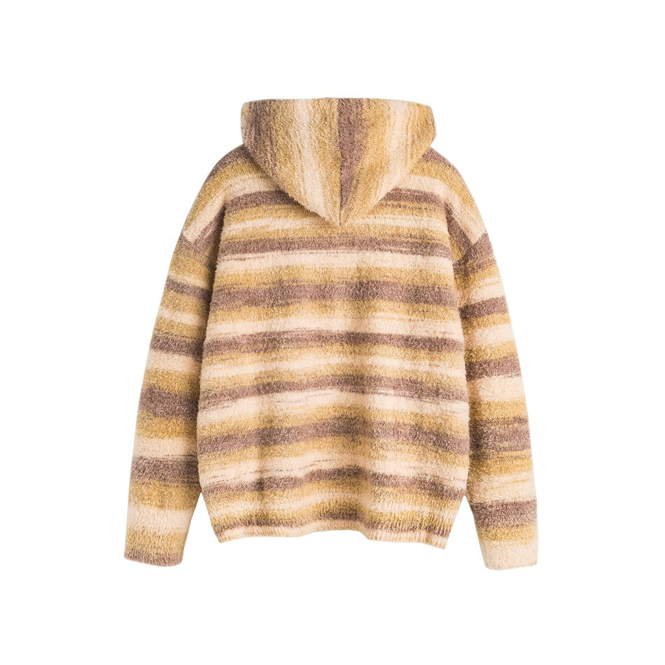 Back view of a fuzzy hooded pullover with cream, tan, and mauve horizontal stripes, shown flat against white.
